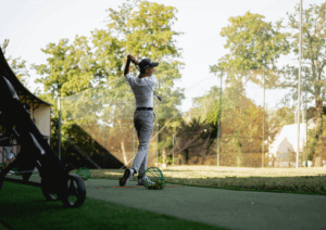 Jeune golfeur débutant en swing sur practice